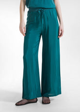 PANTALONI PALAZZO IN SATIN VERDE - PEACOCK GREEN | DEHA